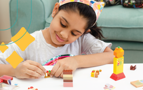 young girl plays with LEGOs