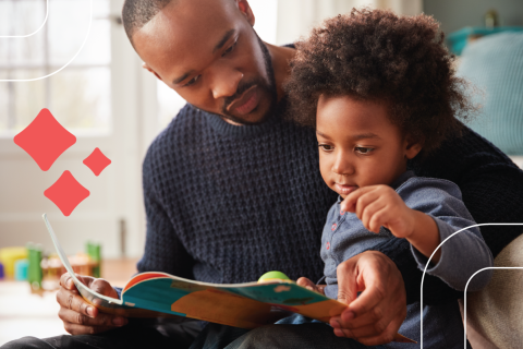 a dad reads to a child aged 2-5 sitting in his lap