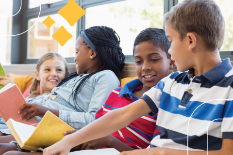 four kids aged 8-12 read together under a row of windows