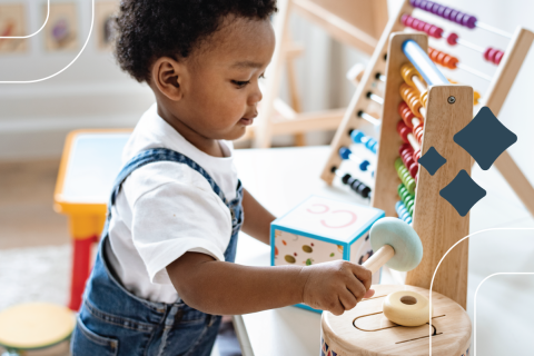 a child aged 2–5 plays with wooden educational toys