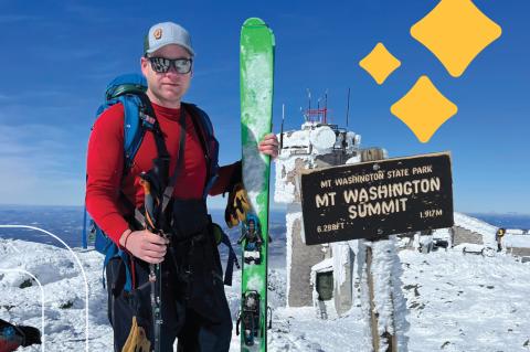 Derek Schroeter stands atop Mt. Washington with his skis and poles on a sunny winter day