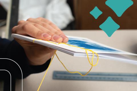 hand stitches pamphlet together