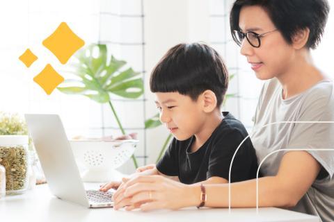Image of an Asian woman with a young Asian boy looking at a laptop computer together.