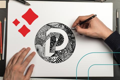 image of hands drawing an intricate doodle on paper.