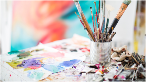 brushes and art supplies on a table