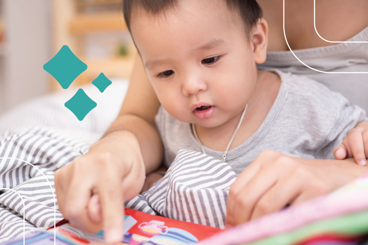 a baby looks at a picture book while sitting in their mom's lap