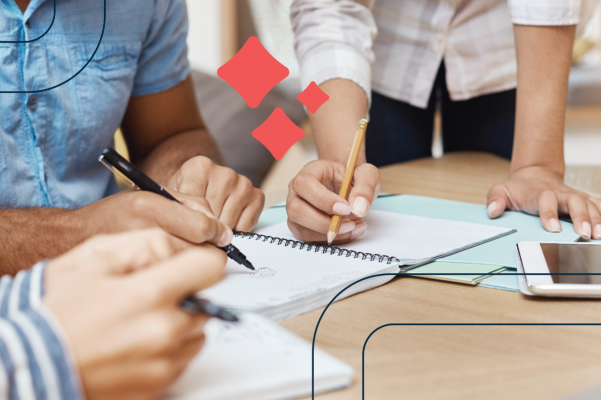 the hands of three people holding pens work on a project together in a notebook