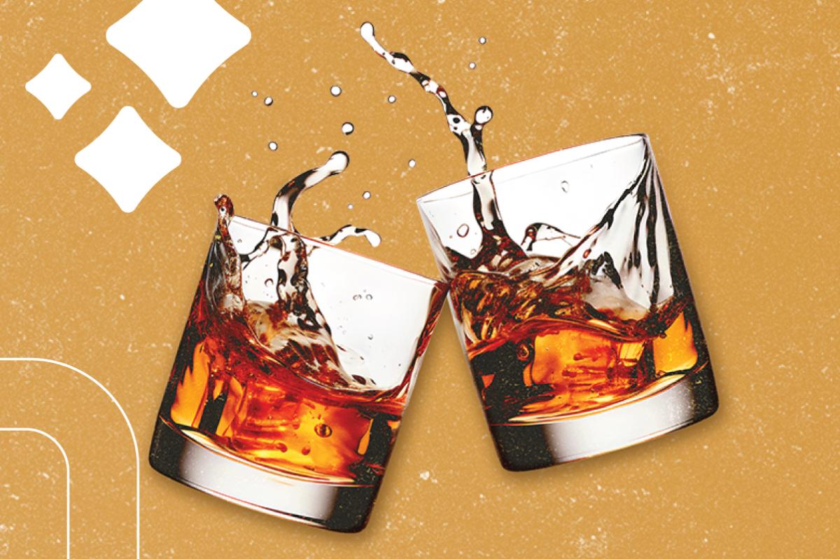 two whiskey glasses clink together